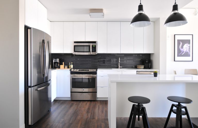 Short-stay apartment kitchen with benchtops and stovetop cleaned and disinfected