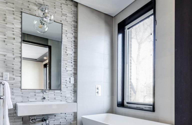 Bathroom with the vanity, toilet, bathtub and shower screen cleaned and polished