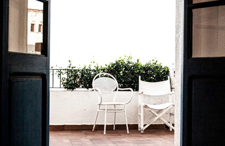 Apartment balcony with outdoor furniture wiped down and rubbish removed